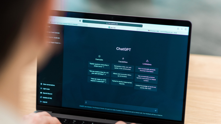 Close view of a man with opened AI chat on laptop